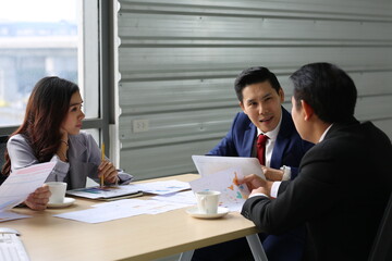Businessman Giving Speech On Business Meeting With Colleagues, Discussing Work Ideas And Projects, Making Presentation Standing In Modern Office. Teamwork, Entrepreneurship, Corporate Meeting