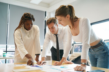 Fototapeta premium Image of young business people discussing document in paperwork data on desk at meeting