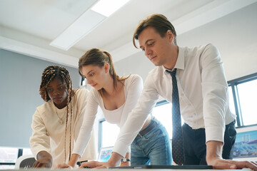 Fototapeta premium Image of young business people discussing document in paperwork data on desk at meeting