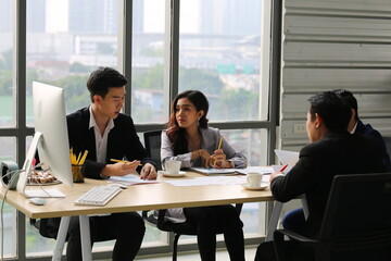 Young Asian business team people meeting in office