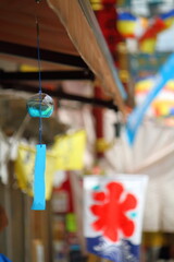 Blue wind chime in Japan, with the summer street background.