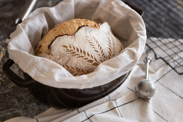 Yeast-free bread with a beautiful pattern, rich pastries at home on a black grate in the kitchen.