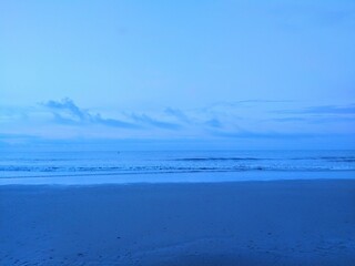 Soft Blue Early Morning Beach Waves and Clouds