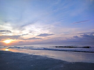 Fototapeta na wymiar Beach Ocean Bright Orange Sunrise