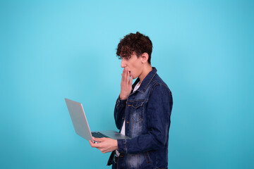 Cheerful funny student with a laptop.	