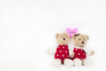 love message card handwriting on pink heart with couple teddy bear arrangement flat lay postcard style on background white 