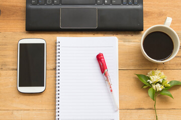 notebook planner, mobile, computer for business work arrangement flat lay style on background wooden