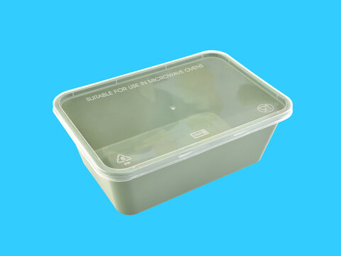 Empty Closed Green Plastic Food Box Packaging Isolated On Blue, Microwave Safe Plastic Container With Clear Lid For Food Delivery Service Or Picnic