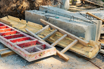 Building materials at a construction site. Prepared materials and embedded parts for foundations at a construction site. Formwork for grillages and foundations.