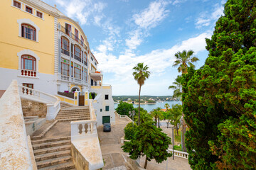 Fototapeta na wymiar View of the Georgian architecture, Mediterranean Sea and port harbor from the grand staircase leading to the historic old town of Mahon or Mao on the Island of Menorca, Spain.