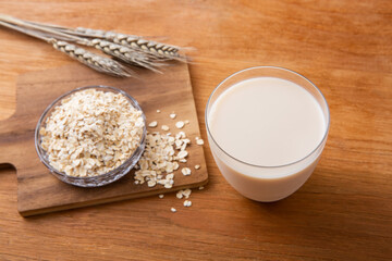 Oat milk on wooden table