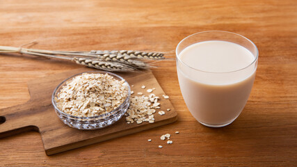 Oat milk on wooden table