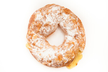 Round bun with custard, powder and almonds