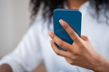 Black businesswoman with smartphone in hand, closeup