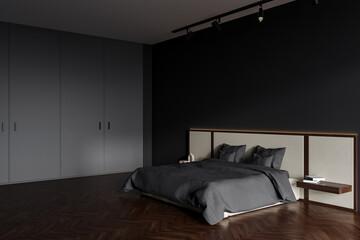 Dark bedroom interior with bed, empty grey wall