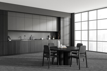 Grey kitchen interior with eating table and chairs, kitchenware and window