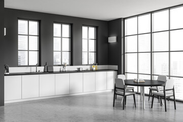 Grey kitchen interior with eating table and chairs, kitchenware and window
