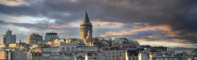 Fototapeta premium Panoramic Cityscape of a part of Istanbul city showing homes and Galata tower at sunset