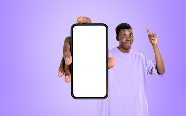 Fototapeta na wymiar African man show mockup display smartphone on violet background