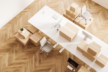 Top view of office interior with armchair and moving boxes