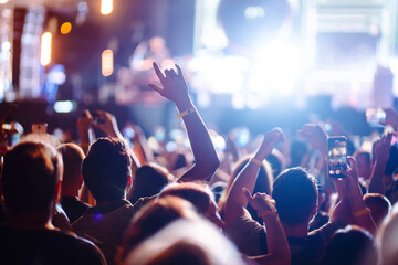 Crowd raising their hands, dancing and enjoying great the concert. Summer holiday, vacation 