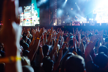 Crowd raising their hands, dancing and enjoying great the concert. Summer holiday, vacation 