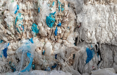 Close-up of a pile of compressed plastic waste at a waste recycling plant - obrazy, fototapety, plakaty