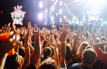 Fototapeta na wymiar Crowd raising their hands, dancing and enjoying great the concert. Summer holiday, vacation 