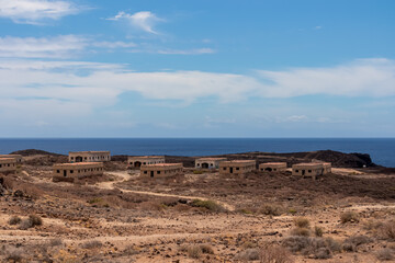 Panoramic sea view on the abandoned leper village of Sanatorio de Abona near Abades beach, east coast Tenerife Spain. Pueblo fantasma de Abades, an unnfinished project of leprosy hospital. Ghost town