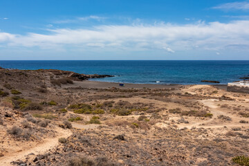Panoramic sea view on Abades beach in Poris de Abona on the east coast of Tenerife, Canary Islands, Spain. Hiking trail leading to a pebble beach in a remote holiday resort. Sunny day, summer vacation