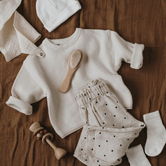 Cute hygge pastel clothes, accessories for newborn baby. Muslin bib, sweater, joggers, socks,...