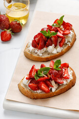 Strawberry dessert. Appetizer with ricotta cheese, cream cheese, honey, strawberry, mint. Toast, snack, bruschetta. Sweet Sandwich.