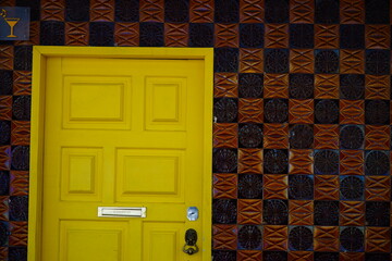 Yellow door with texture wall in Lisbon, Portugal