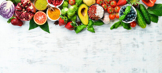 Diet food concept: fresh vegetables and fruits on white wooden background. Free space for your text.