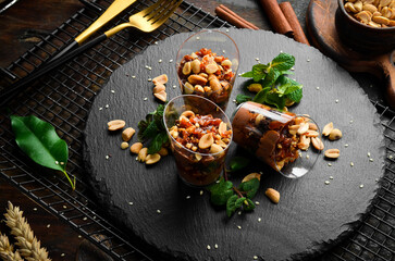 Chocolate peanut dessert in plastic cups. Candy bar. Top view. Rustic style.