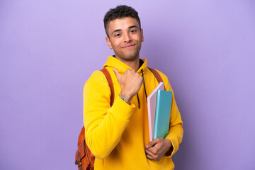 Young student Brazilian man isolated on purple background proud and self-satisfied