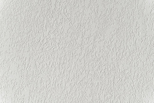 White wall with plaster background. Plaster and putty grain surface texture. Finishing, decor concept.