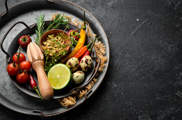 Spices, vegetables and herbs on a metal tray. Food background. Top view. Rustic style.