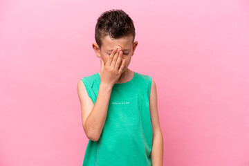 Little caucasian boy isolated on pink background with headache