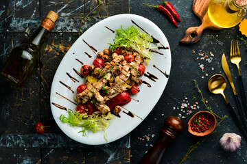 Healthy food. Chicken breast with grilled vegetables on a white plate. Top view.