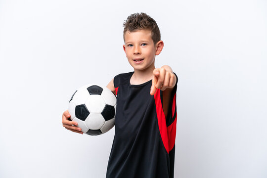 Little caucasian boy isolated on white background with soccer ball and pointing to the front