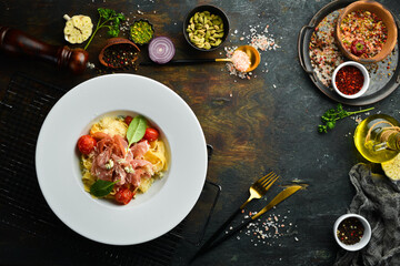 Pasta with prosciutto, blue cheese and tomatoes. Italian cuisine. Menu. Top view.