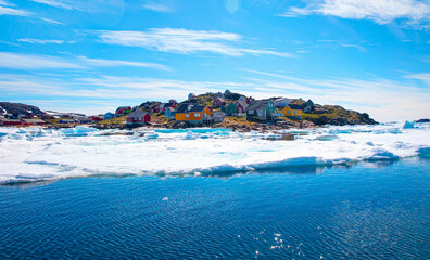 Fototapeta premium Arctic landscape of Greenland in Summer. Beautiful view of mountains with Snowy peaks and iceberg