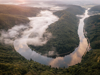 Foggy morning at Saarschleife river loop in Saarland, Germany. Aerial drone view