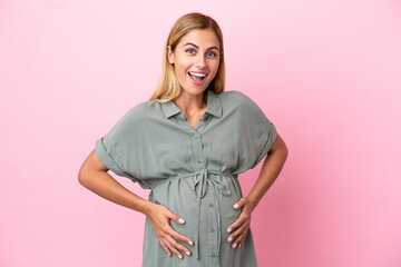 Young Uruguayan woman isolated on blue background pregnant and doing surprise gesture