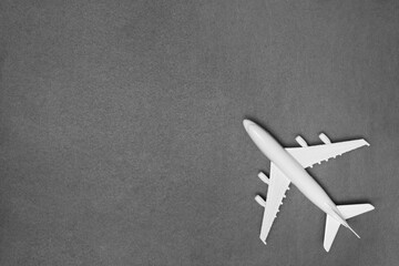 Airplane model. White plane on gray background. Travel vacation concept. Summer background. Flat lay.