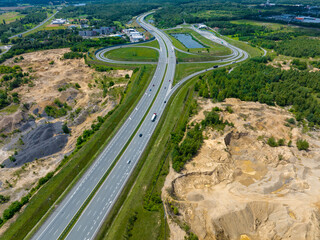 The motorway running through the former mining areas. Mining heaps, near Bytom, Poland. 