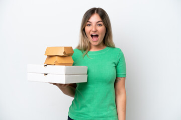 Young Rumanian woman holding fast-food isolated on white background with surprise facial expression