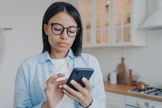 Concentrated woman texting and consulting online or using application. Distant work on quarantine.
