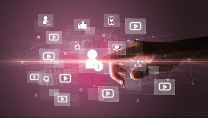 Fototapeta premium Hand pressing social media multimedia application screen with media icons on futuristic concept